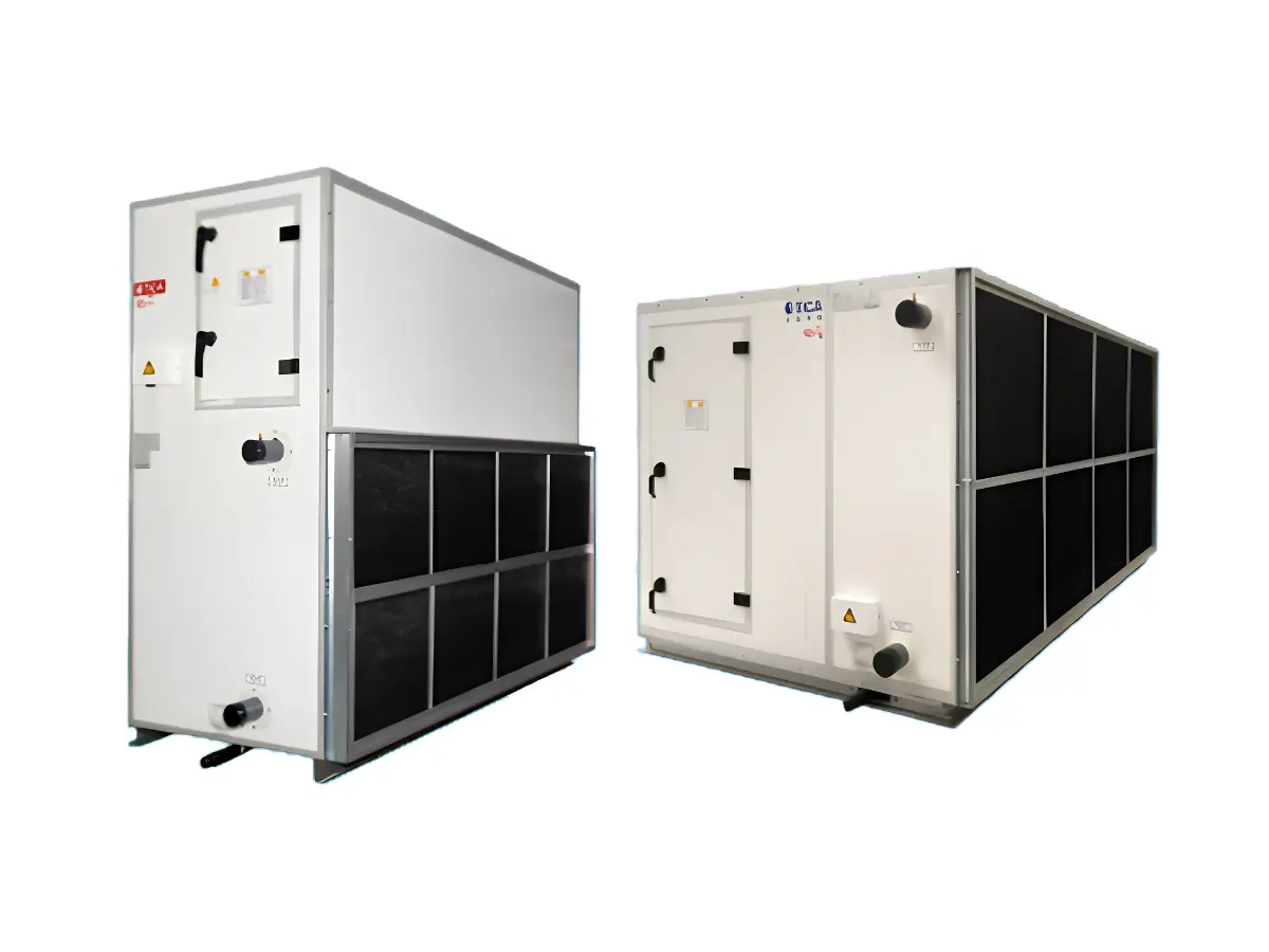 Two large industrial HVAC units with white metal panels, black grilles, access doors, warning labels, and control knobs, used for air handling in commercial buildings.